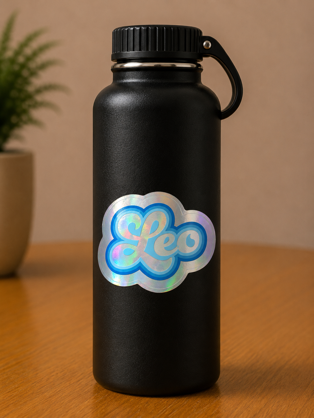 Leo holographic zodiac vinyl sticker displayed on a black water bottle with bold retro lettering.