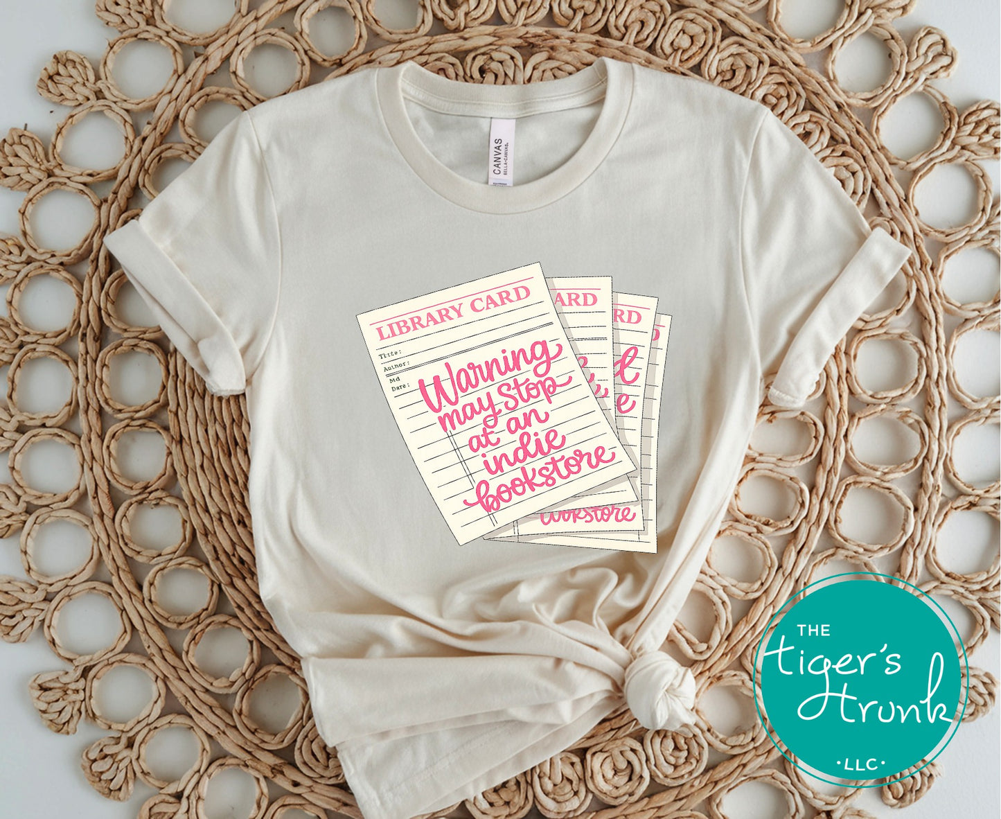 Library card shirt with warning may stop at an indie bookstore design on cream, navy, mauve, sage, sand, fatigue green, and maroon shirts