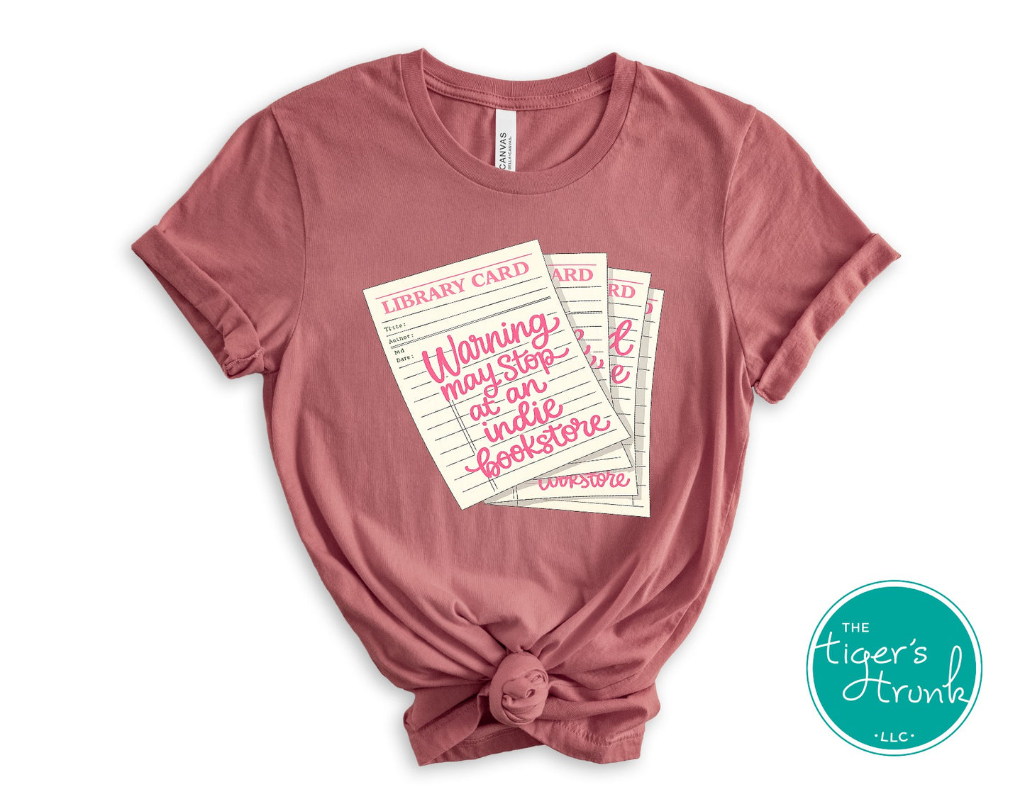 Library card shirt with warning may stop at an indie bookstore design on cream, navy, mauve, sage, sand, fatigue green, and maroon shirts