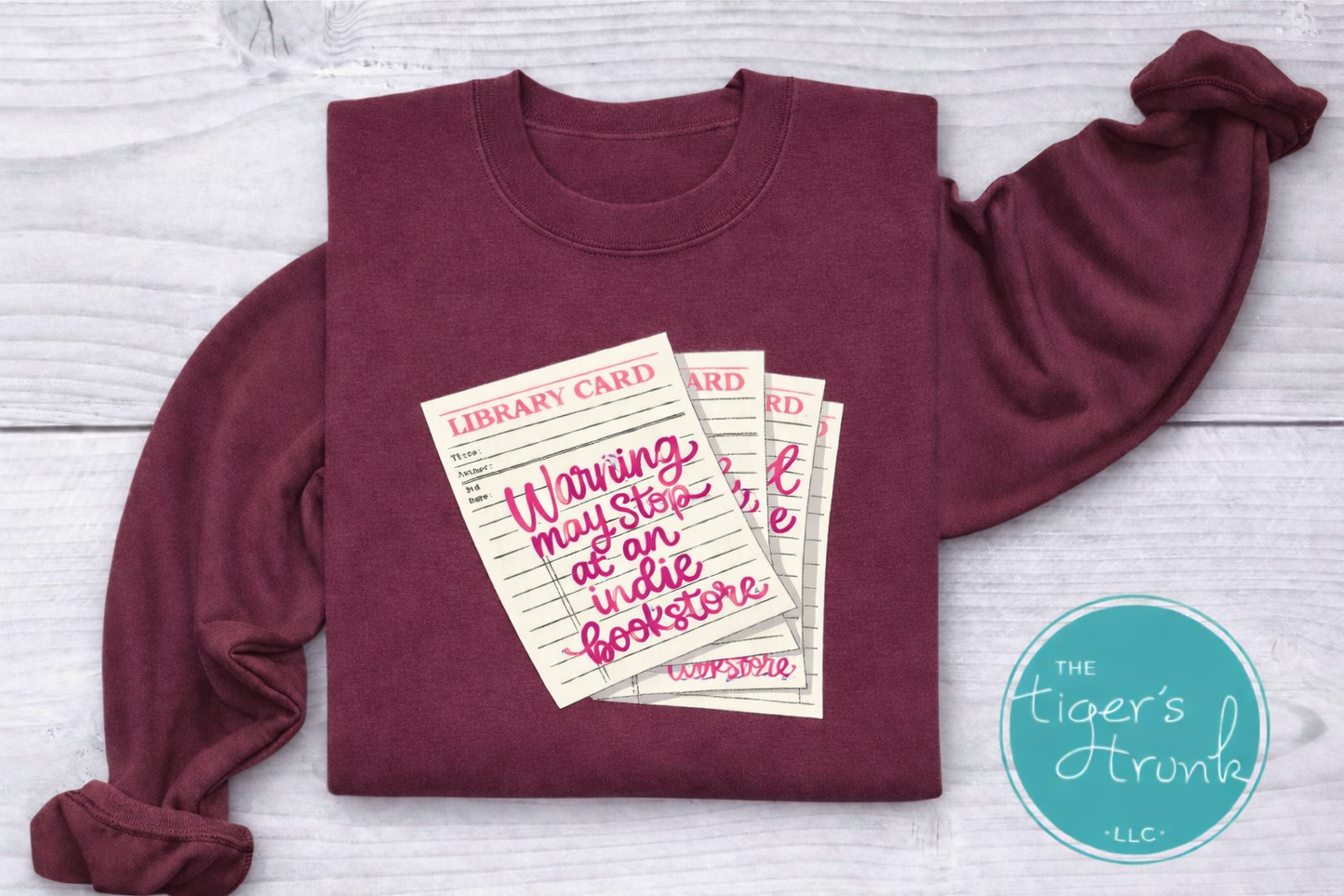 Library card shirt with warning may stop at an indie bookstore design on cream, navy, mauve, sage, sand, fatigue green, and maroon shirts
