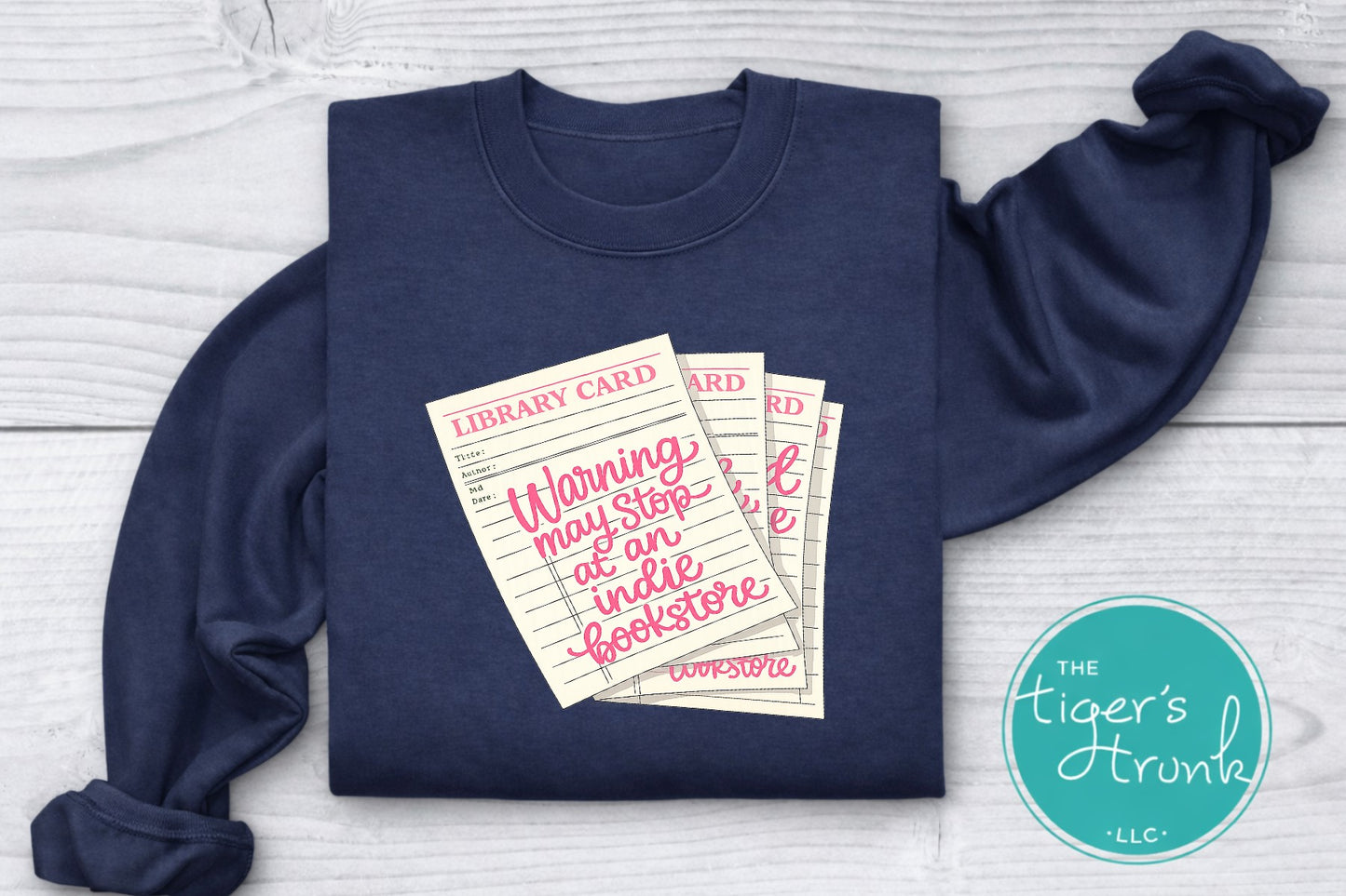 Library card shirt with warning may stop at an indie bookstore design on cream, navy, mauve, sage, sand, fatigue green, and maroon shirts