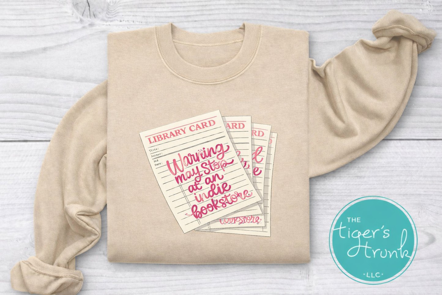 Library card shirt with warning may stop at an indie bookstore design on cream, navy, mauve, sage, sand, fatigue green, and maroon shirts