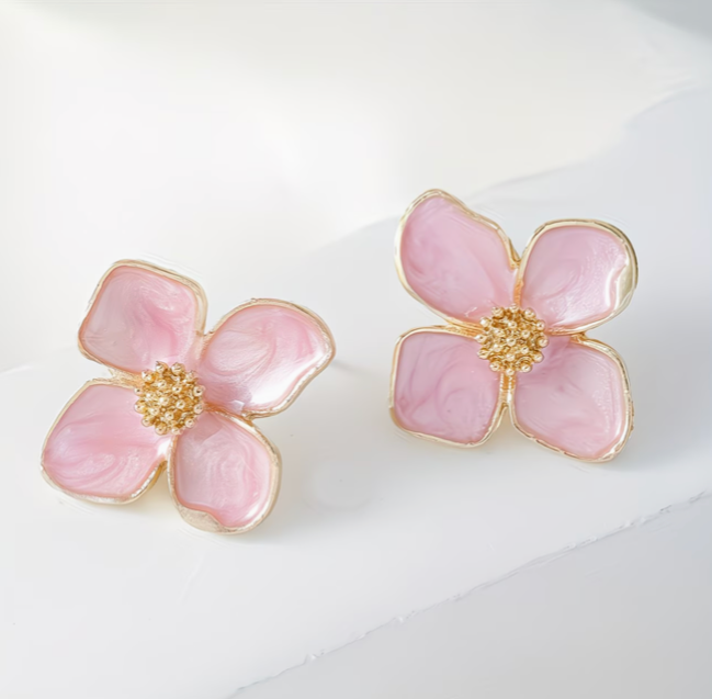 Light pink floral stud earrings with soft marbled enamel petals and gold center
