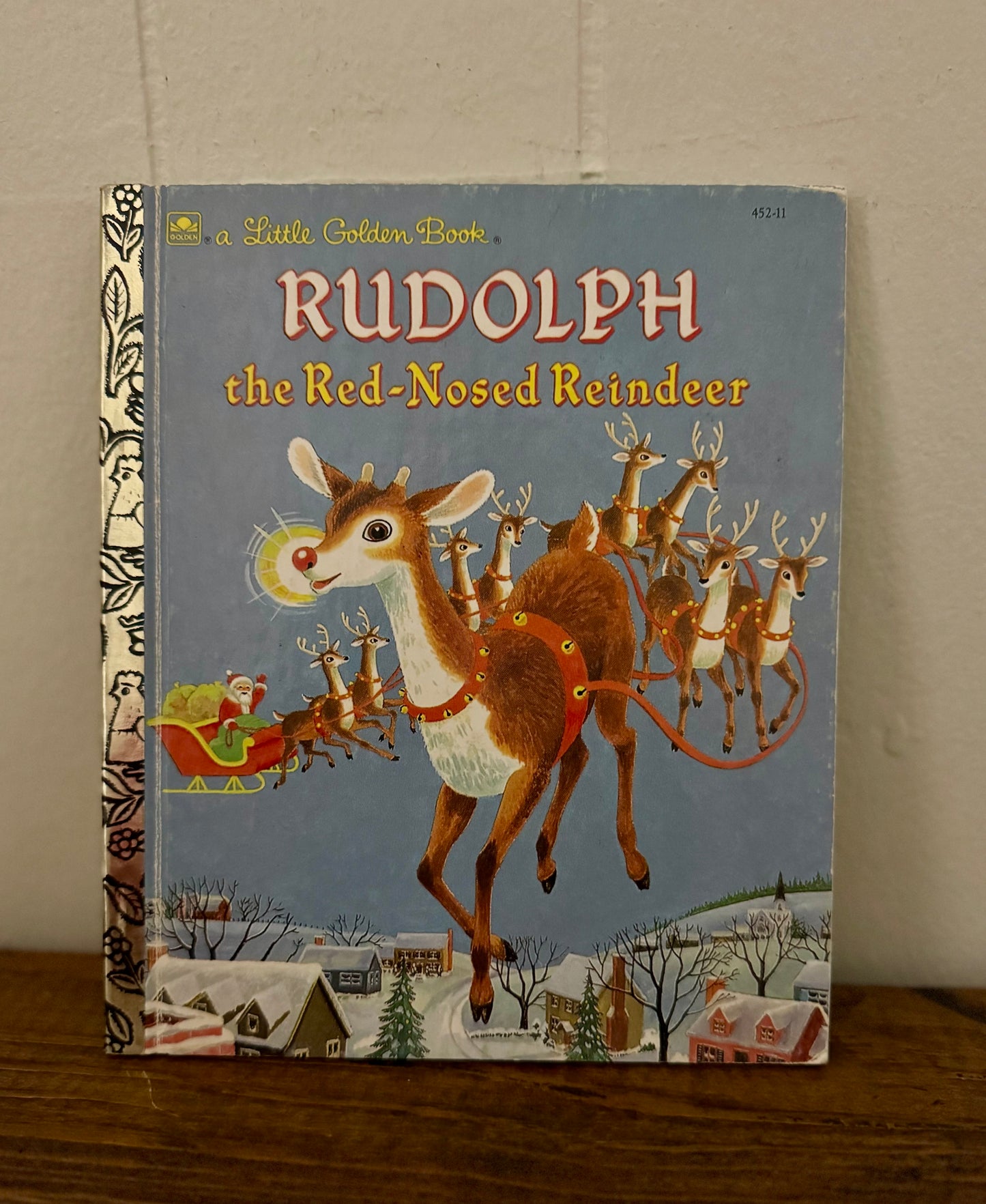 Book titled 'Rudolph the Red-Nosed Reindeer' with a vintage cover design.
