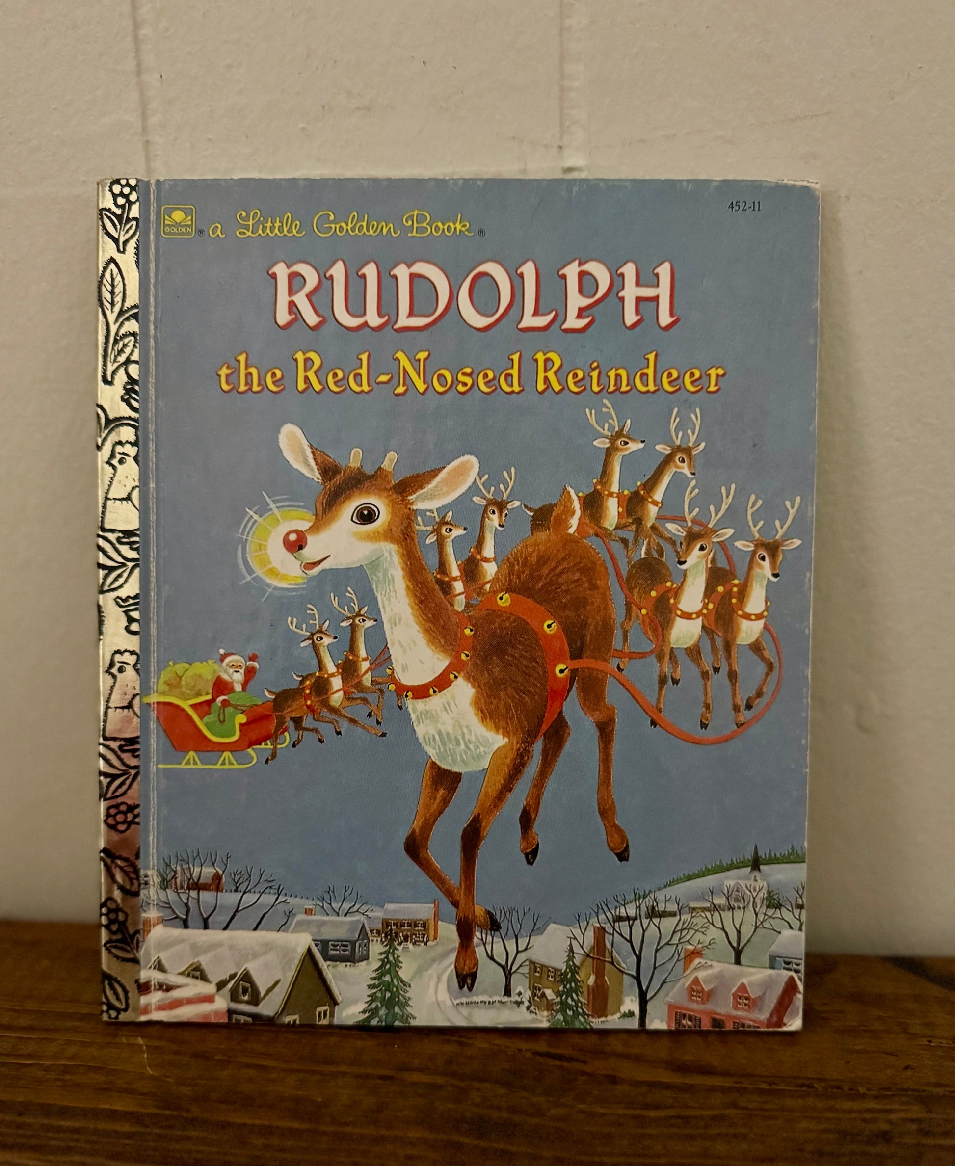 Book titled 'Rudolph the Red-Nosed Reindeer' with a vintage cover design.