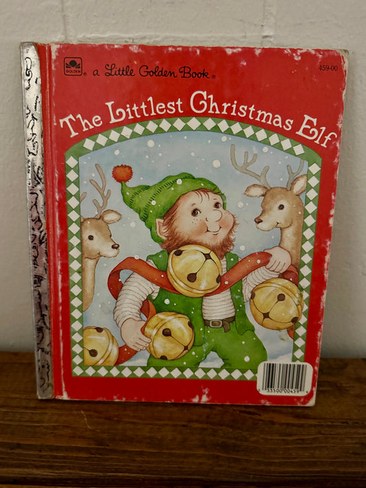 Vintage Little Golden Book titled The Littlest Christmas Elf with a red cover, foil spine, and an illustration of an elf holding jingle bells; fair+ condition.