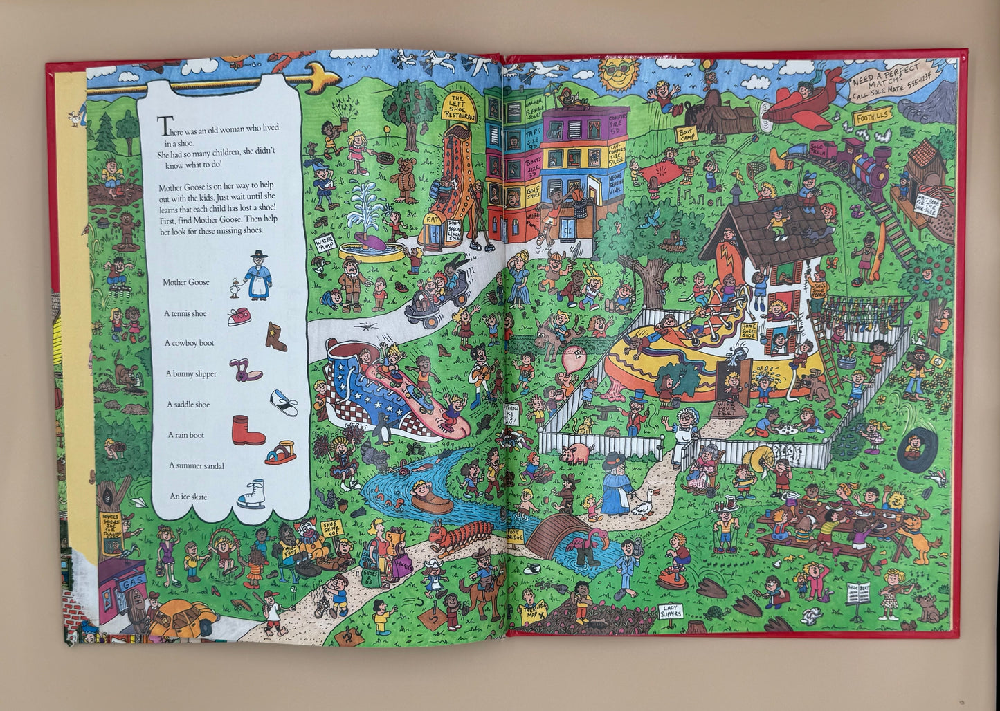 Open book with a colorful illustration of a village scene on a beige background