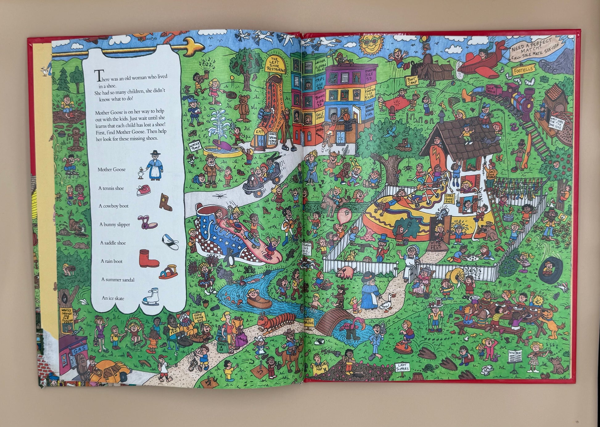 Open book with a colorful illustration of a village scene on a beige background