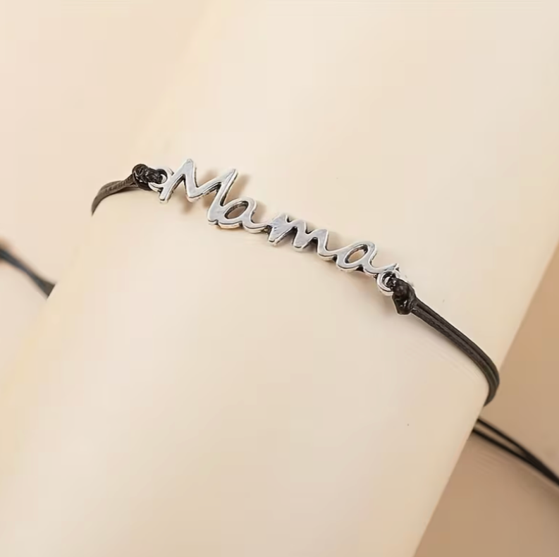 Close up of adjustable mama bracelet worn on wrist with silver lettering