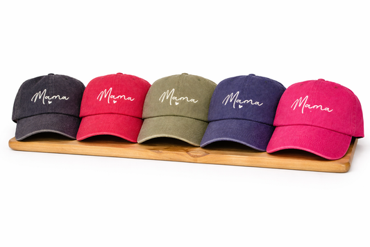 Acid-washed baseball cap with embroidered mama text shown in multiple colors including black, red, navy, pink, and olive with adjustable back closure