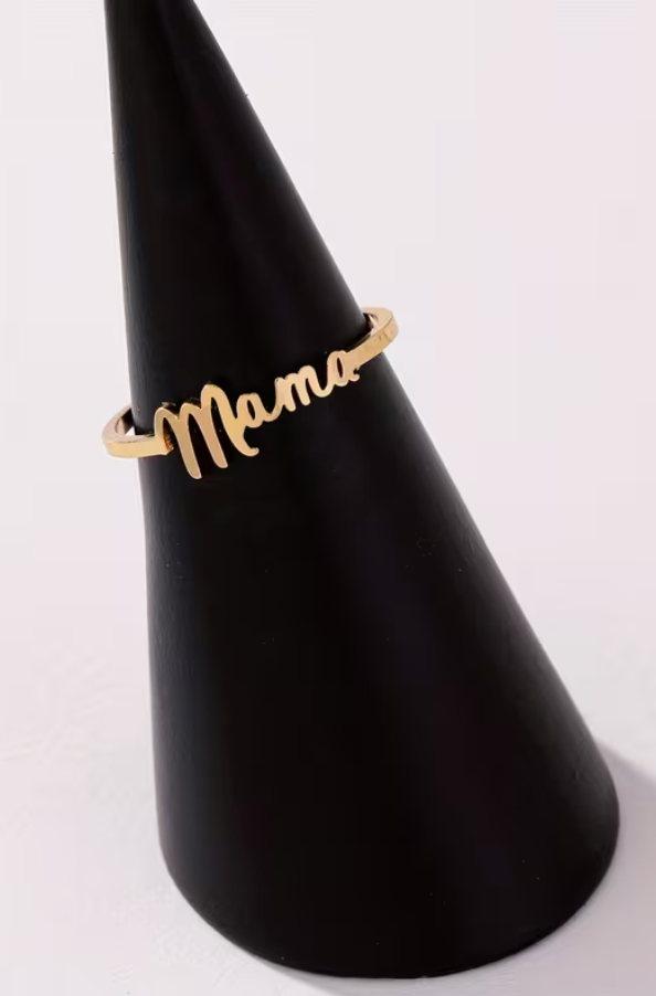 Gold tone adjustable Mama script ring displayed on a black cone jewelry stand against a neutral background.