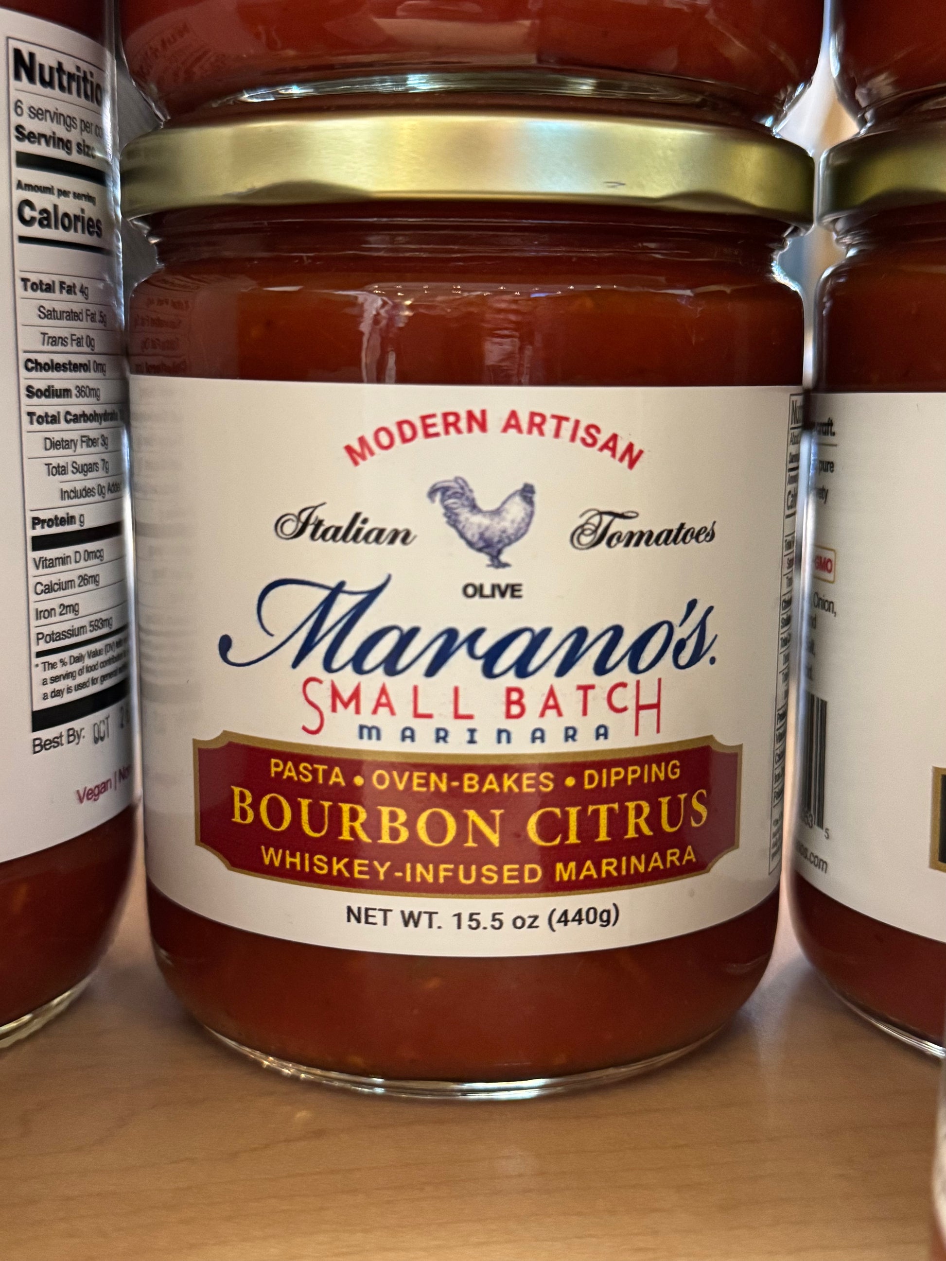 Jar of Marano's Small Batch marinara sauce with label on a wooden surface