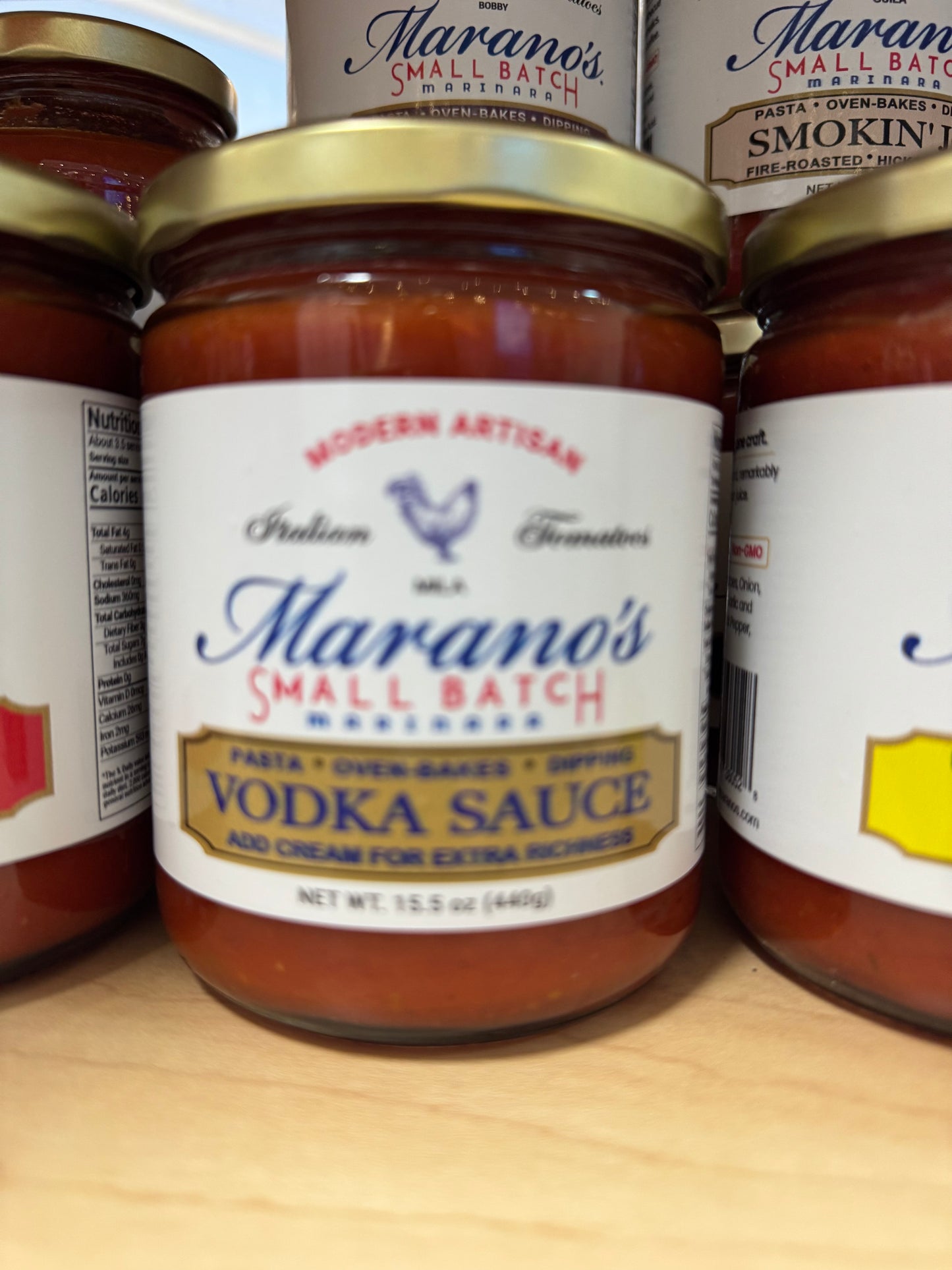 Jar of Marano's Small Batch Vodka Sauce with other jars in the background.