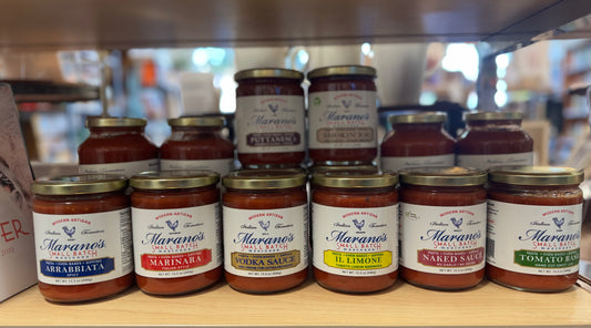 Shelf with various jars of Marano's pasta sauces in a store setting