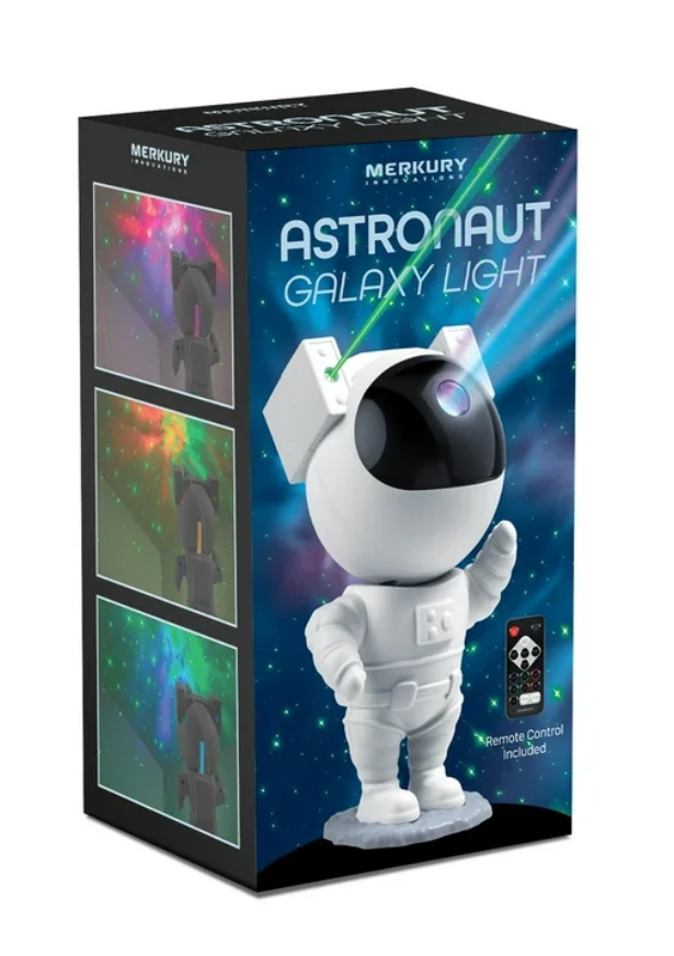 Retail packaging for the Merkury Astronaut Galaxy Light projector showing the white astronaut figure on the front of the box with example galaxy light effects and a remote control icon.