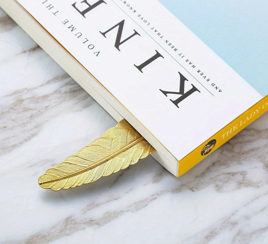 Metal bookmark shaped like a feather with a sleek, antique finish—perfect for readers and gift-giving.