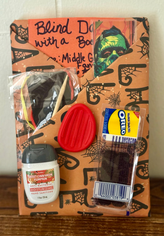 Halloween-themed snack bag with candy and a book inside