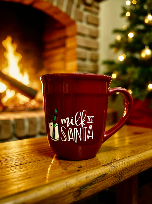 Red Milk for Santa ceramic mug sitting near a fireplace and Christmas tree