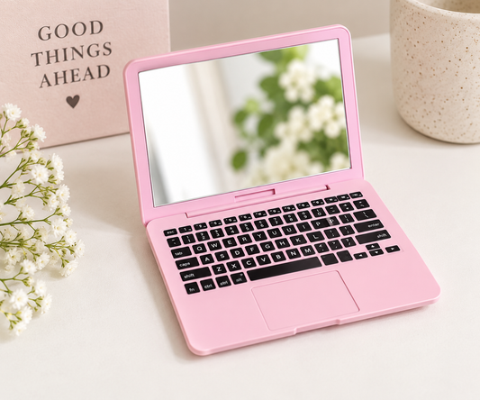 Pink mini laptop compact mirror open on a desk with realistic keyboard design