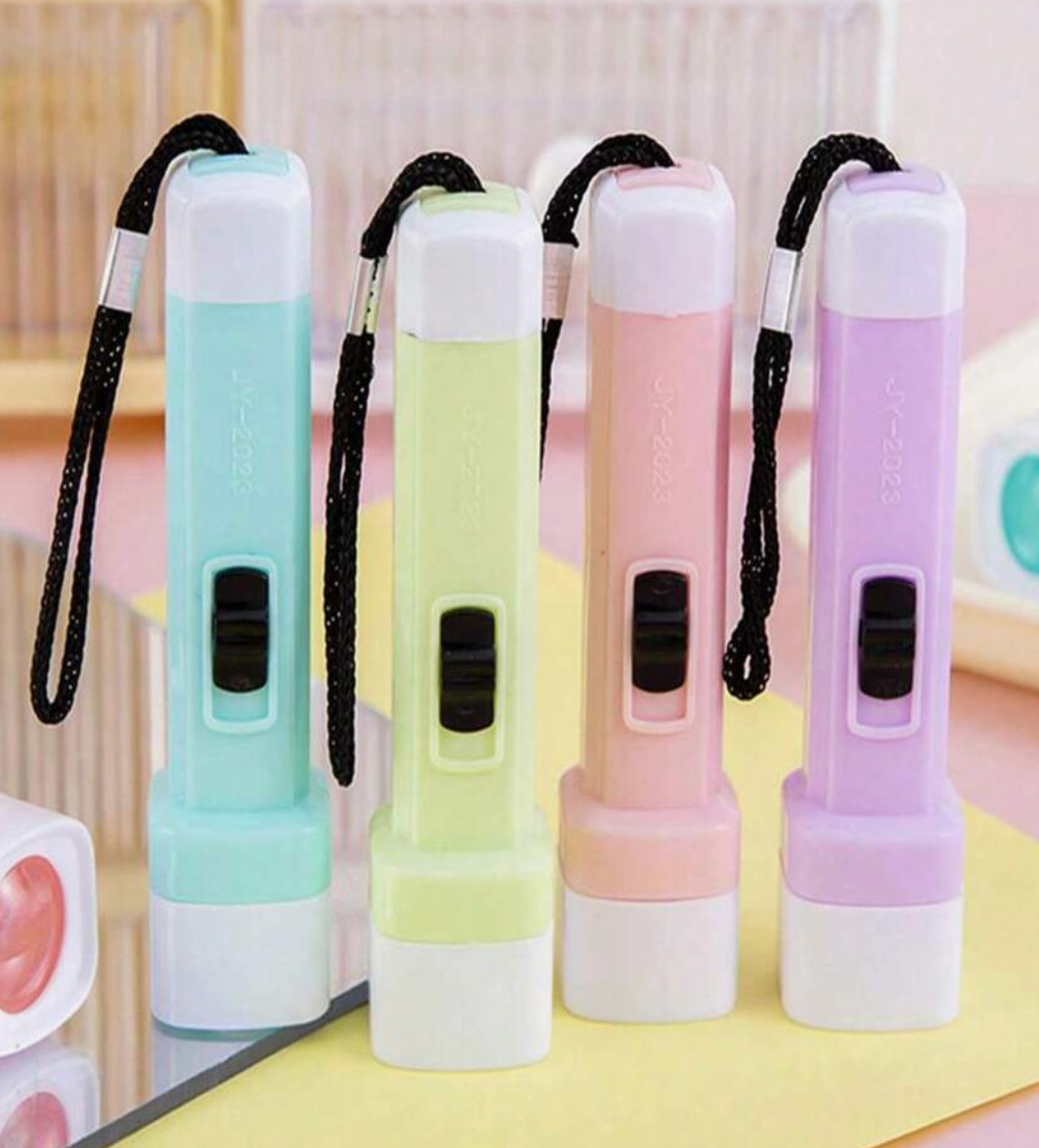 Pastel mini LED flashlights in blue, green, pink, and purple standing upright with wrist straps.