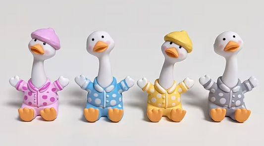Assorted miniature pajama goose resin figurines in pink blue yellow and gray