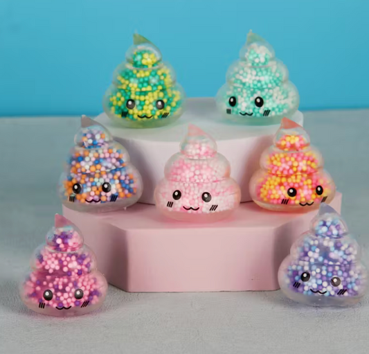 Mini colorful poop-shaped squishy fidget toy filled with tiny foam beads and featuring a smiling kawaii face.