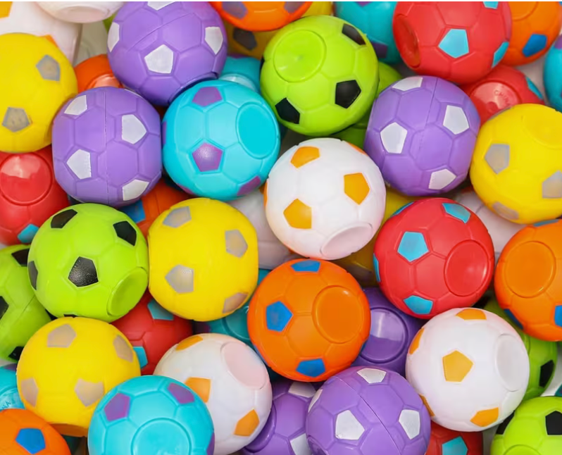 Assorted colorful mini soccer ball fidget toys in purple, yellow, green, orange, red, blue, and white, measuring approximately 1.38 inches wide