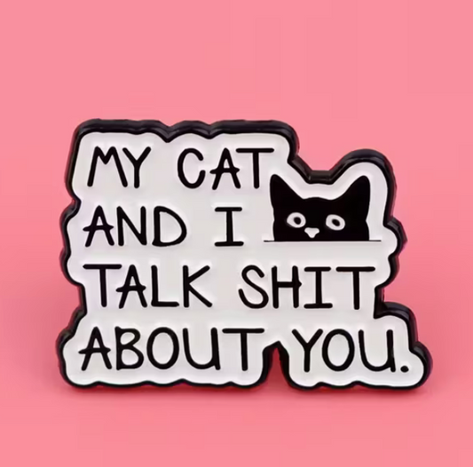 Funny cat enamel pin with bold text that reads My Cat and I Talk Shit About You on a pink background.