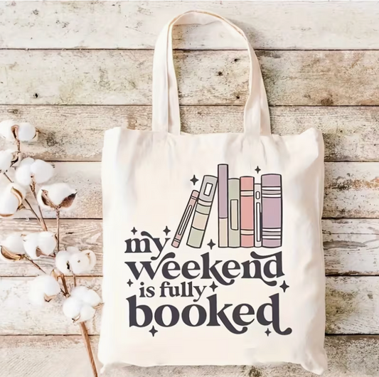canvas tote bag with my weekend is fully booked design featuring pastel books and book lover quote