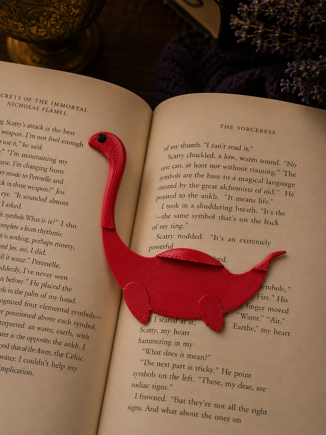 Red dinosaur-shaped bookmark on an open book