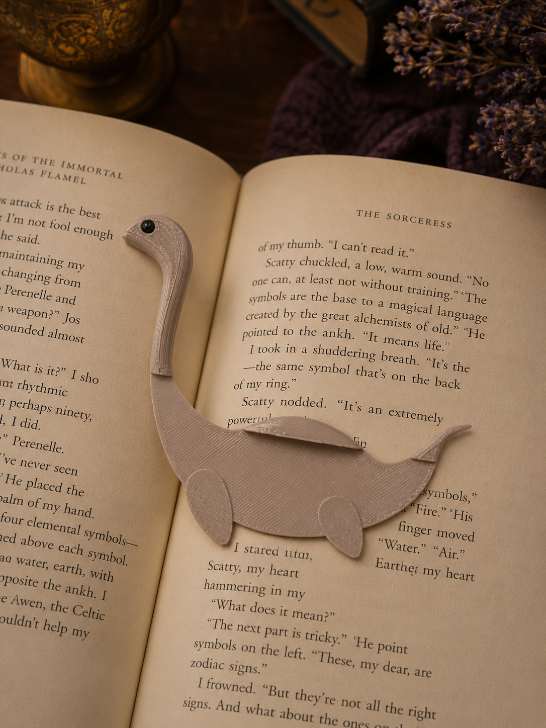 Dinosaur-shaped bookmark on an open book