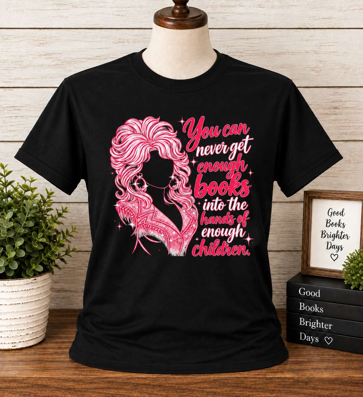 Black bookish T-shirt with pink Dolly-inspired graphic and You Can Never Get Enough Books Into the Hands of Enough Children quote