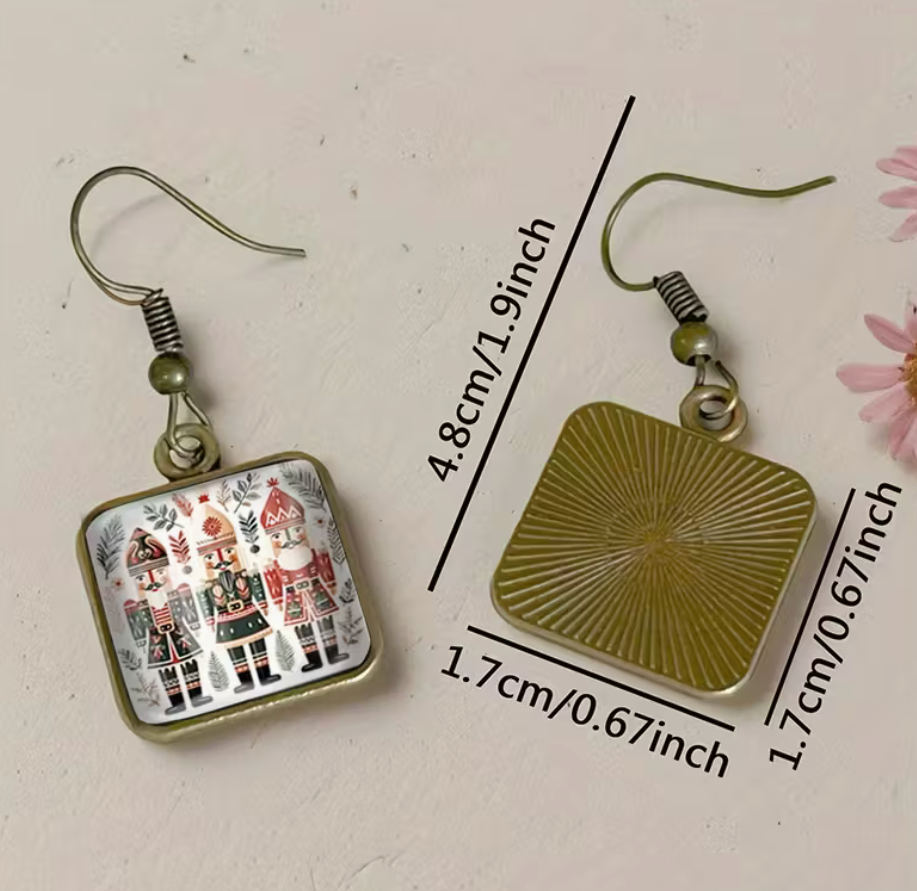 Square glass nutcracker Christmas earrings shown with size measurements