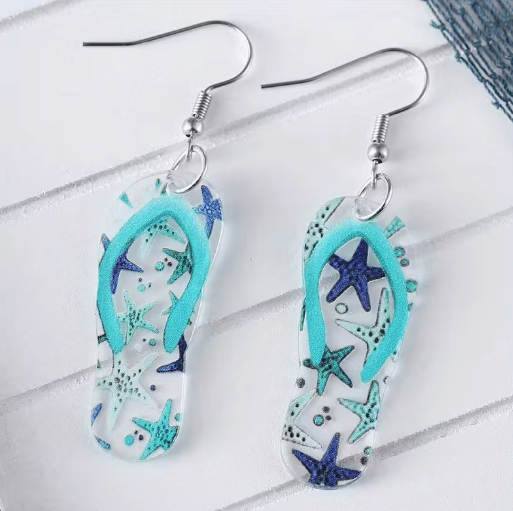 Ocean-themed flip-flop pendant earrings with blue starfish details and silver hooks