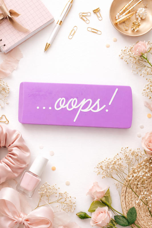 Large purple novelty eraser with the words …oops! printed on it displayed as a funny desk accessory