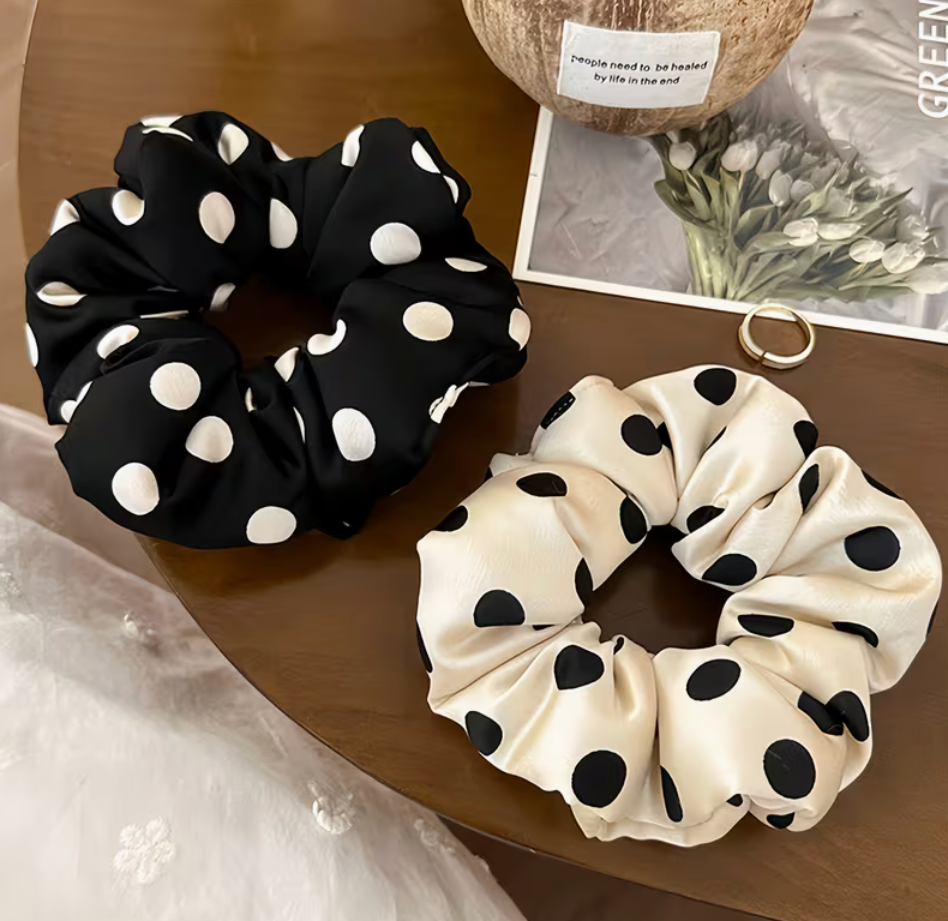 Oversized polka dot scrunchies in black with white dots and cream with black dots, sold individually
