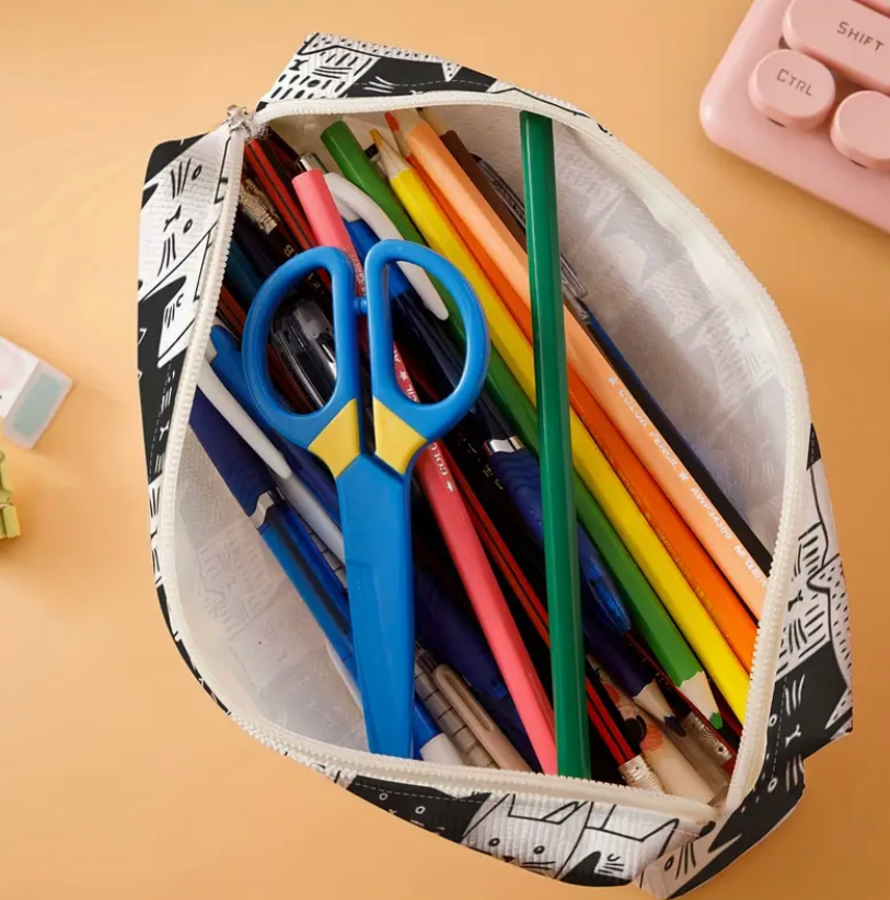 Pencil case with stationery items including pens and scissors on a beige background