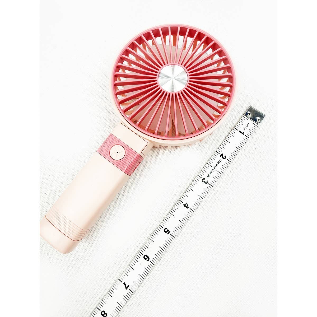 Pink portable hand fan with ruler showing full dimensions