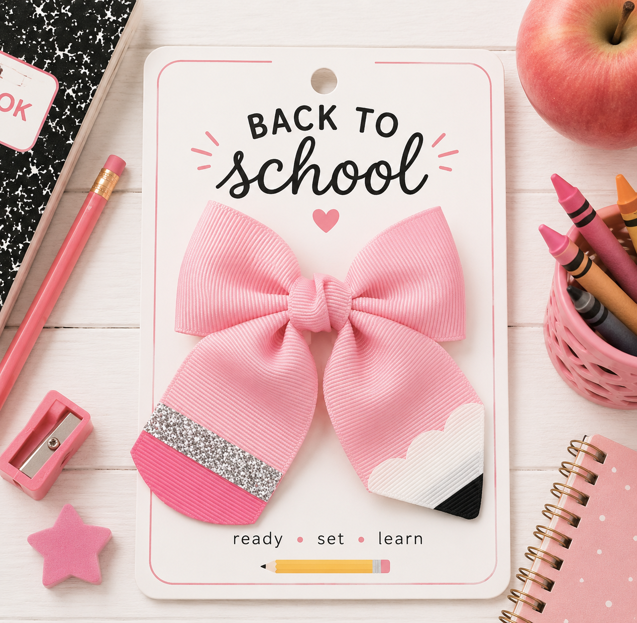 Pink pencil-shaped ribbon hair bow with a glitter silver eraser band and sharpened pencil tip, attached to an alligator clip for back-to-school outfits, teachers, and students.