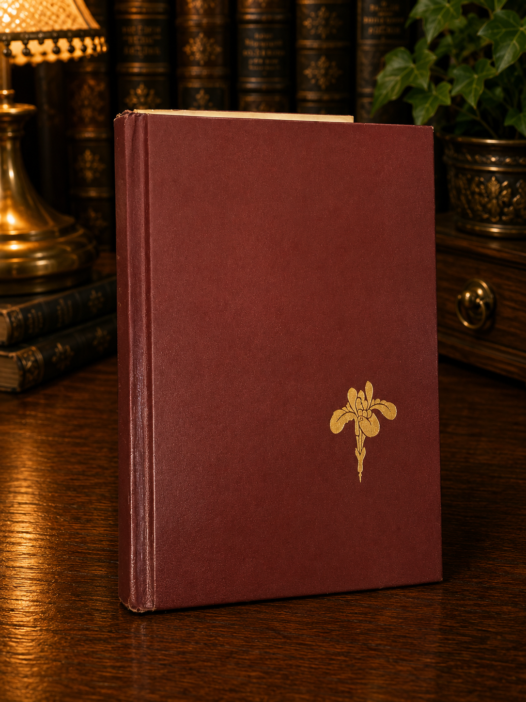 Red hardcover boards with gold floral decoration from Poinciana by Phyllis A. Whitney.