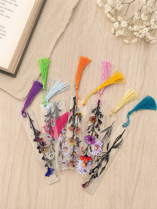 Assorted clear acrylic bookmarks with colorful pressed flower designs and coordinating tassels, sold individually