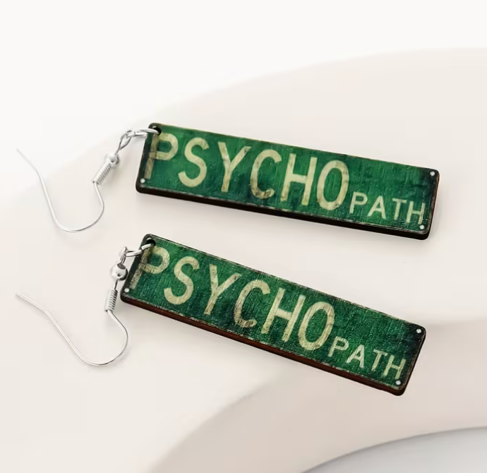 Pair of funny Psycho Path dangle earrings featuring distressed green miniature street signs with cream lettering and silver-tone fishhook closures