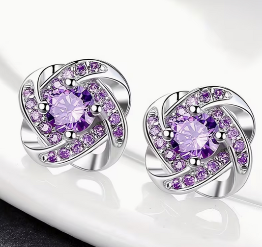 Purple rhinestone knot stud earrings with silver tone setting and crystal details