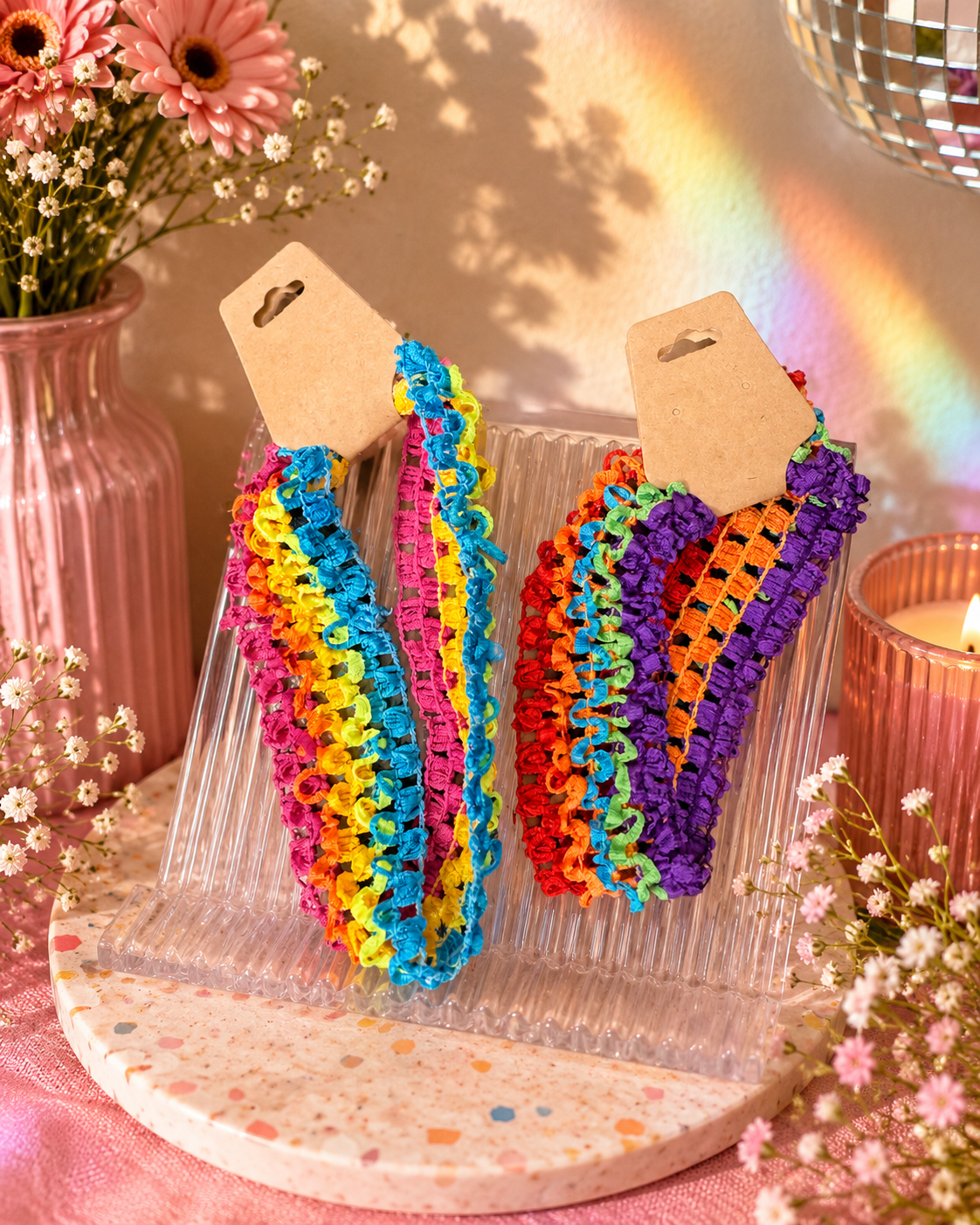Set of colorful stretchy rainbow headbands featuring bright pink, yellow, blue, orange, and green woven elastic bands.