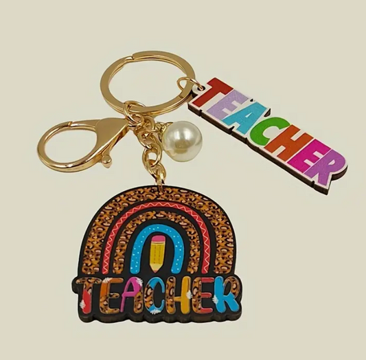 Wooden keychain featuring a rainbow design with the word Teacher engraved—perfect for gifting educators with a pop of color and appreciation.