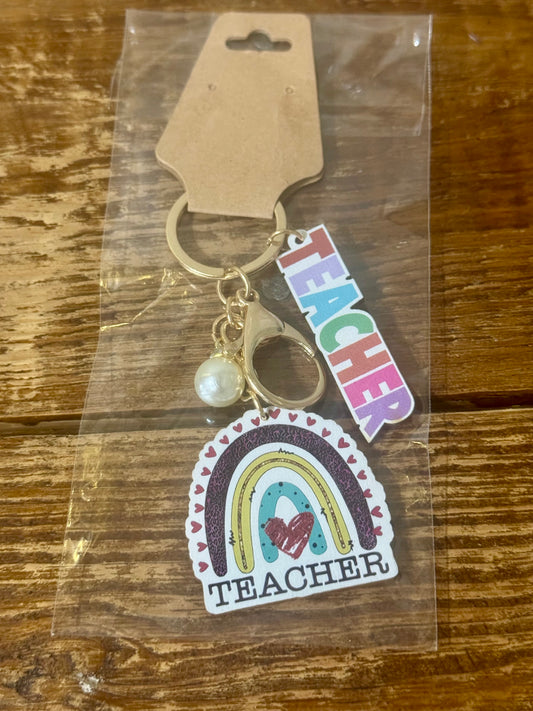  Wooden keychain featuring a rainbow design with the word Teacher engraved—perfect for gifting educators with a pop of color and appreciation.