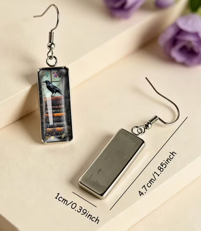 Raven and antique book rectangular earring with silver-tone hook measuring approximately 1.85 inches long