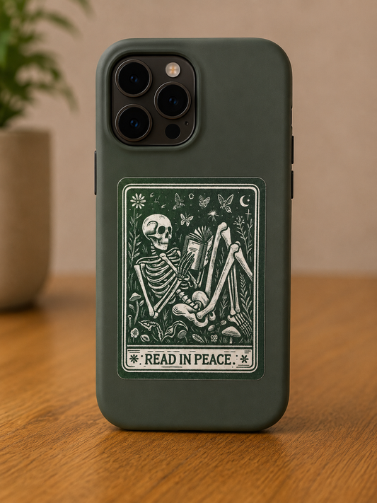 Vintage-style Read in Peace vinyl sticker featuring a skeleton reading a book surrounded by flowers, butterflies, and woodland details.