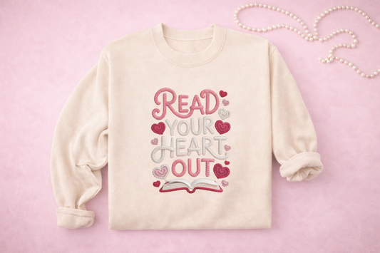Cream-colored sweatshirt with 'Read Your Heart Out' text and hearts on a pink background