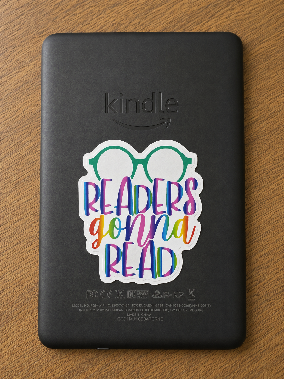 Colorful Readers Gonna Read die cut vinyl sticker with reading glasses displayed on the back of a Kindle e-reader.